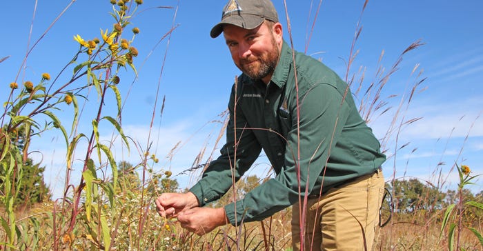 Jordon-Beshears standing in grass and plants