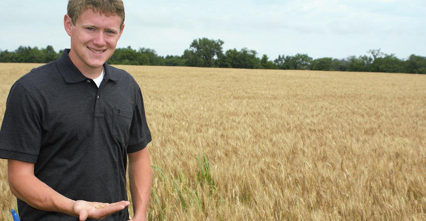 Garrett Cramer holds a handful of wheat