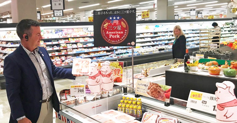 Tim Chancellor examines a U.S. pork promotional display in Japan