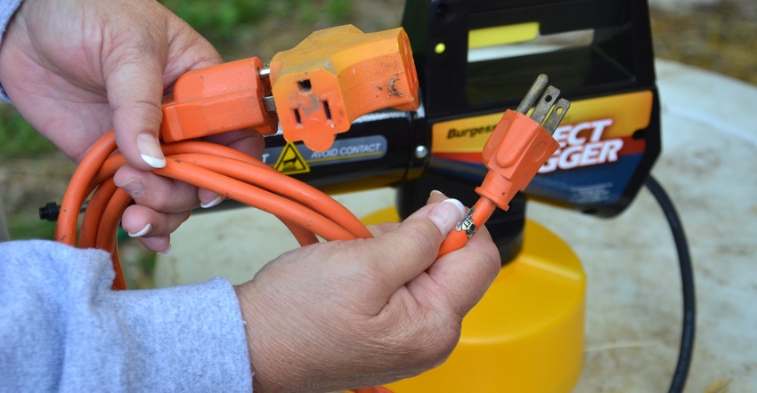 hands holding extension cord hands holding extension cord