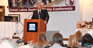 Tom Vilsack, former secretary of agriculture standing at podium speaking at the Great Lakes Regional Dairy Conference