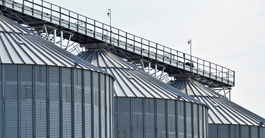 Three large grain bins. Three large grain bins.