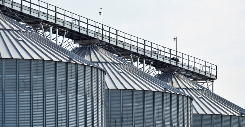 Three large grain bins.