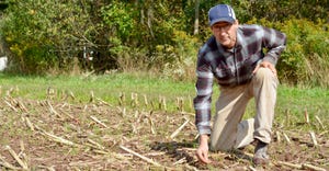 Dean Jackson examines soil in a no-till field