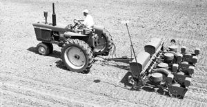 black and white photo of John Deere 494 Series planter pulled by tractor 