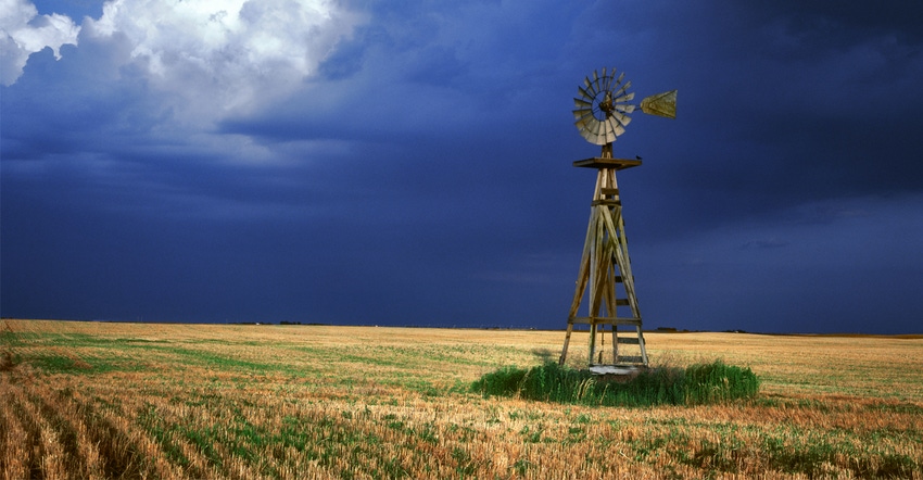 Windmill against stormy sky