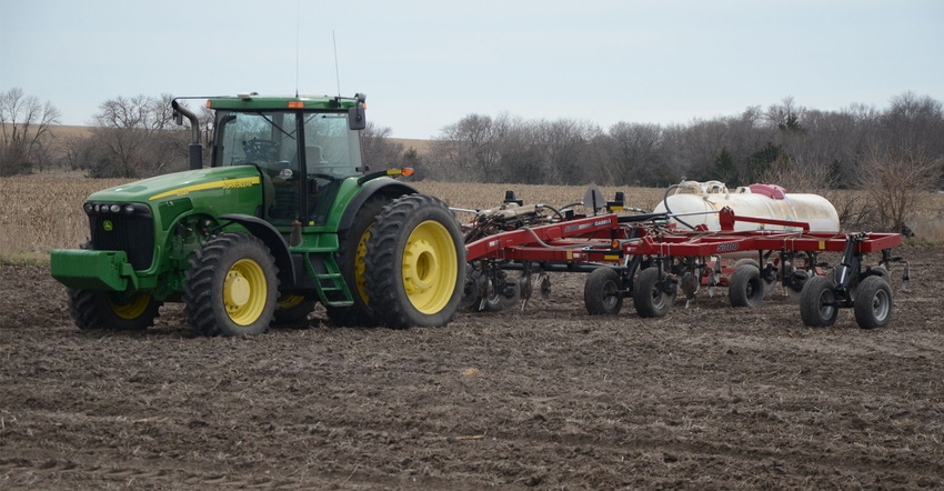 sprayer applying anhydrous ammonia  to field