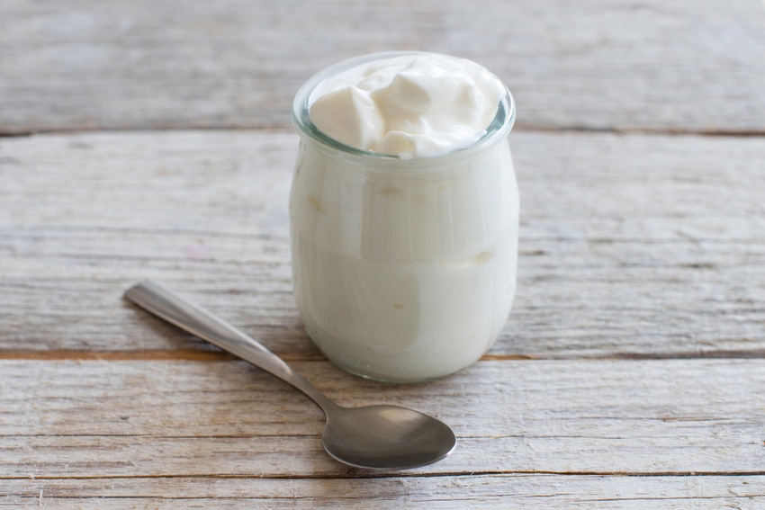 yogurt with spoon on counter