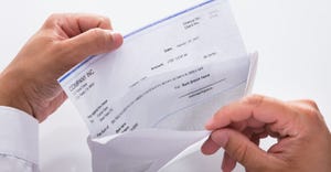 businessman opening envelope with paycheck