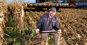 Nick Helland holds a shovel of his cover crop mix