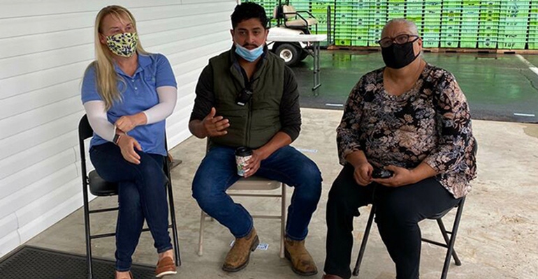 True Blue Berry Management LLC’s Shelly Hartmann (far left), Manuel Morales Jr., and Doraelia Nunez discuss farmworker test