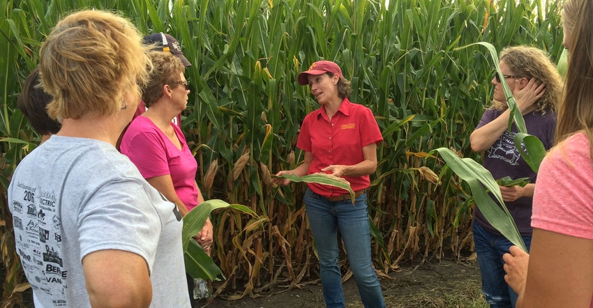 Women gather in cornfield at Agronomy in the Field for Women program offered by Iowa State University Extension