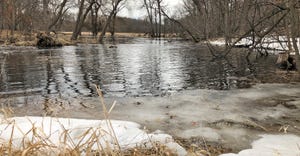 ice and snow on the banks of a creek/ RUNOFF HAPPENS: Data from Discovery Farms in Minnesota and Wisconsin shows that runoff 
