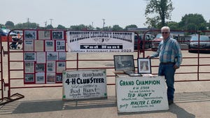  Ted Hunt stands next to displays of his winnings