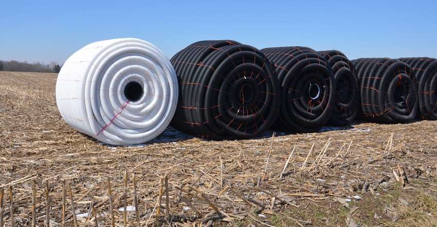 Rolls of tile await installation for a pattern-tile drainage system 