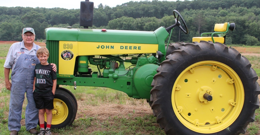 Daryl Dehnke’s grandson Derrick with John Deere tractor