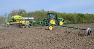 John Deere tractor and planter in field