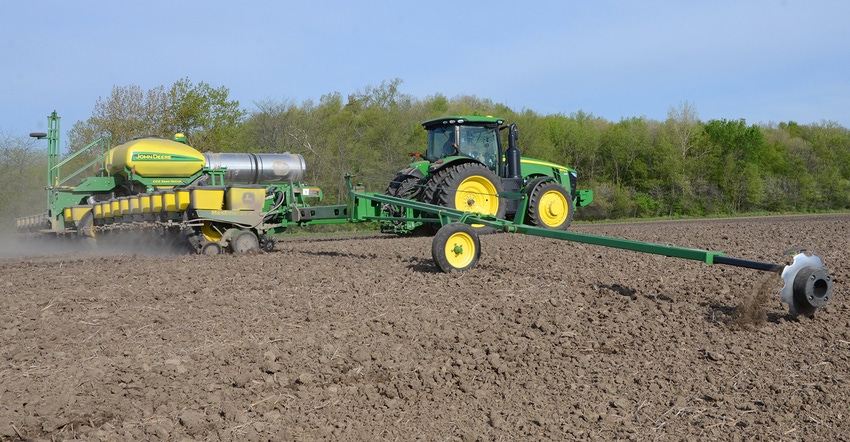 John Deere tractor and planter in field