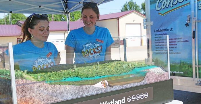 Calaysa Mora, left, and Nicole Haverback help demonstrate the Treatment Wetland model 