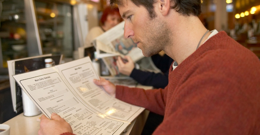 man looking at menu at diner