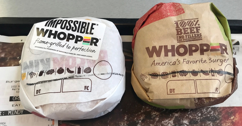 two wrapped burgers side-by-side