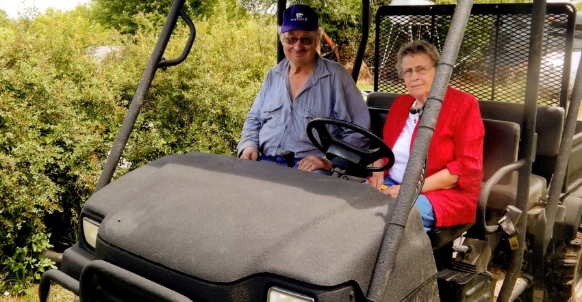 Delores Rieck sitting in an ATV wutg Gary said one of her favorite things is riding out to the fields with Gary