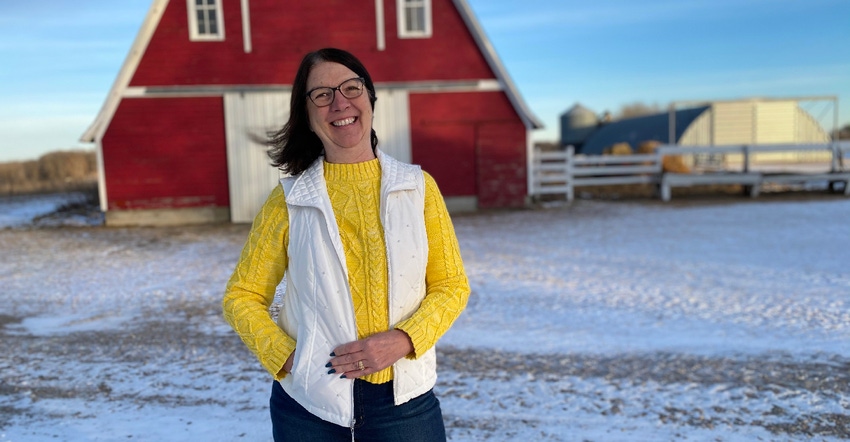Joan Lee standing in front of red barn