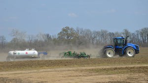 blue tractor pulling nitrogen application equipment