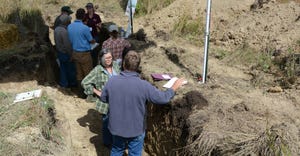 people standing in soil pits during a field day near Granite Falls, Minn., in Sept. 2019