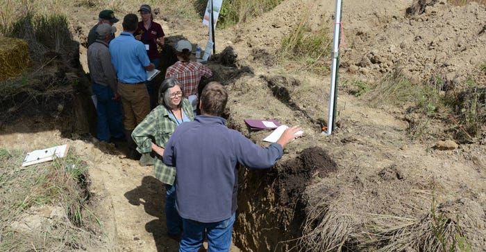 people standing in soil pits during a field day near Granite Falls, Minn., in Sept. 2019 people standing in soil pits during a field day near Granite Falls, Minn., in Sept. 2019