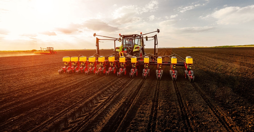 tractor planting farm field at sunset tractor planting farm field at sunset