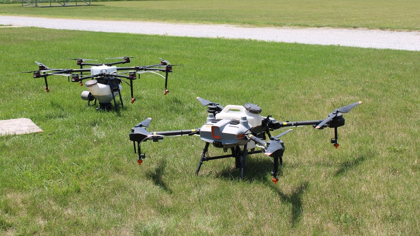 Two drones sit in the grass