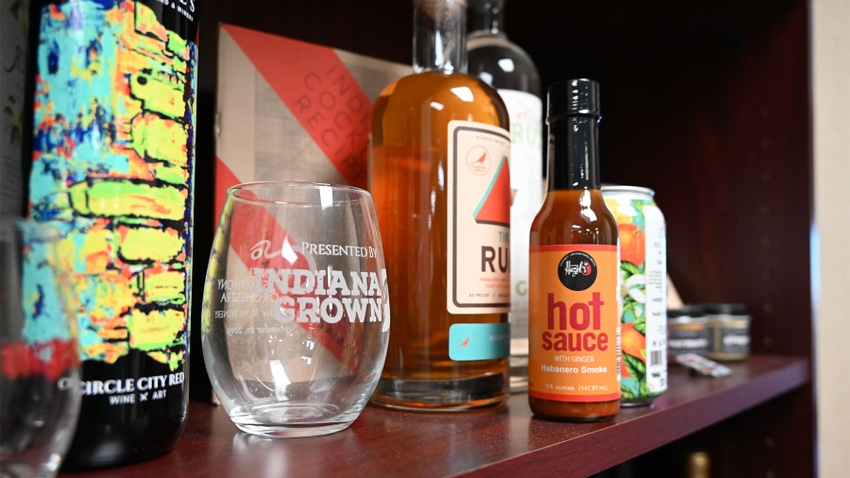 A shelf with Indiana grown products including hot sauce, spirits and wine