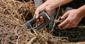 A farmer performs a materials analysis scan using the NeoSpectra Scanner