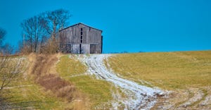 Tobacco barn sitting on a hill with snow covered path