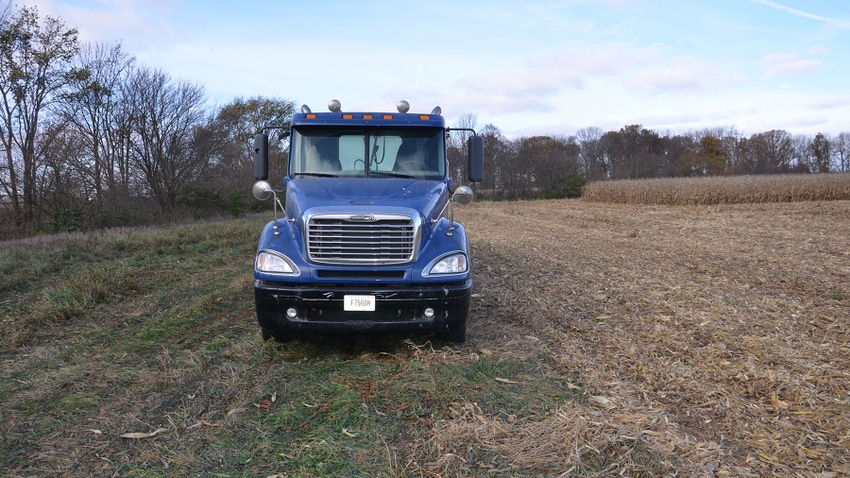 A semi truck parked in a field