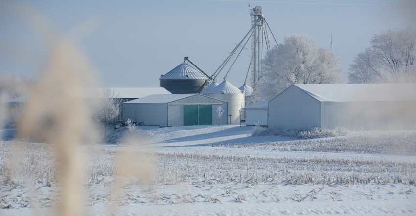 snow covered fields and farm in the distance snow covered fields and farm in the distance