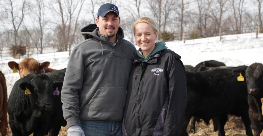 Sarah and Richie Heinrich of Medina, N.D standing in front of cattle