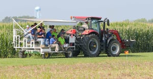 visitors are pulled along by a tractor