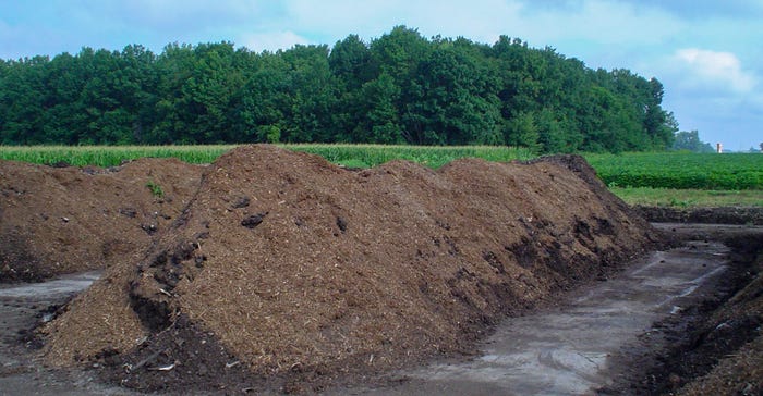 Long rows of compost in a field