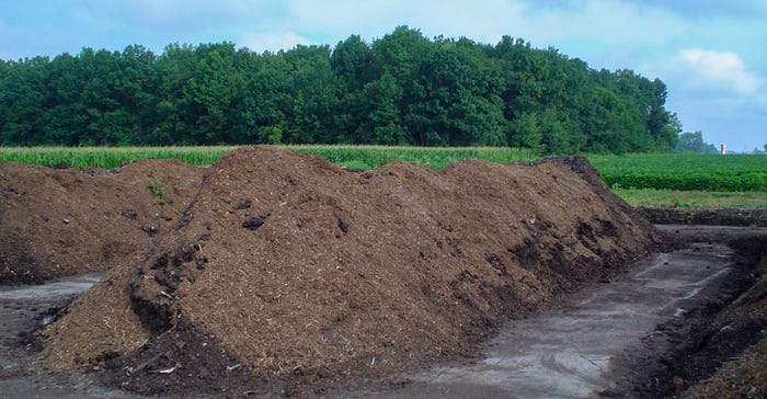 Long rows of compost in a field Long rows of compost in a field
