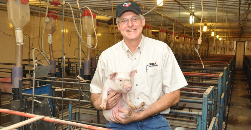 Phil Borgic holding piglet