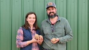 Betsy and Carl Long holding potatoes