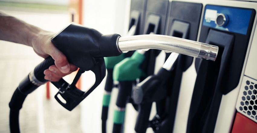 hand holding fuel nozzle at pump hand holding fuel nozzle at pump