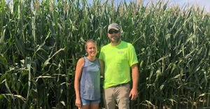 Brandon and Ashley Bonk stand at edge of corn field