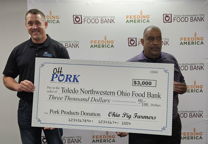 Nick Seger, president of the Ohio Pork Council, presents a check to James Cardwell, president, and CEO of Toledo Northwestern Ohio Food Bank 