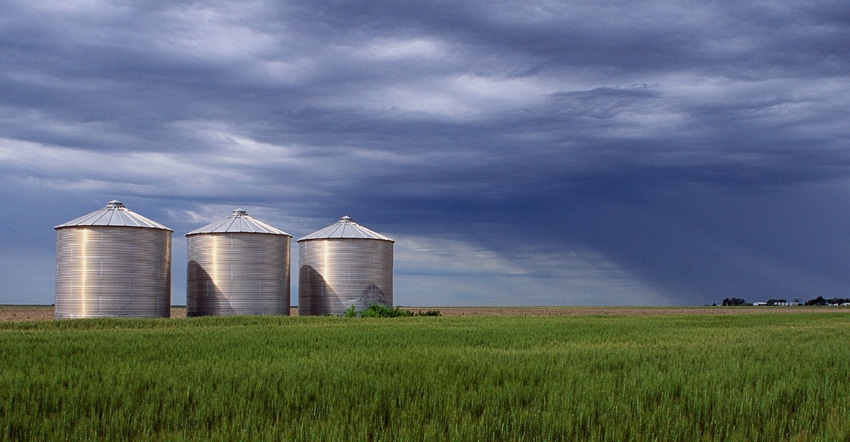 silos in filed under cloudy skies