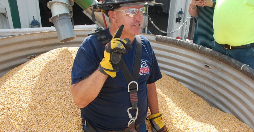 A firefighter participates in a grain bin rescue demonstration