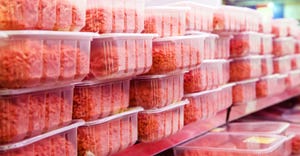 ground beef in plastic containers at a meat market