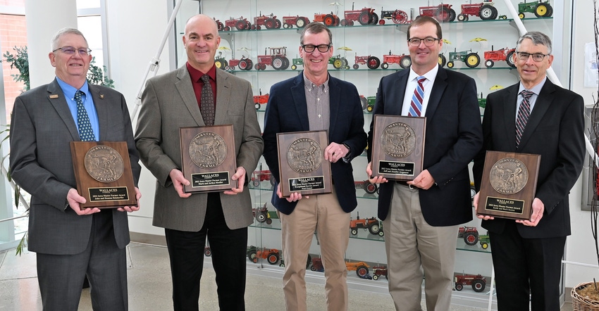 The 2022 class of five Iowa Master Farmers holding plaques The 2022 class of five Iowa Master Farmers holding plaques